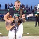 No one was willing to sing the national anthem, so one high schooler took off his helmet and grabbed a guitar